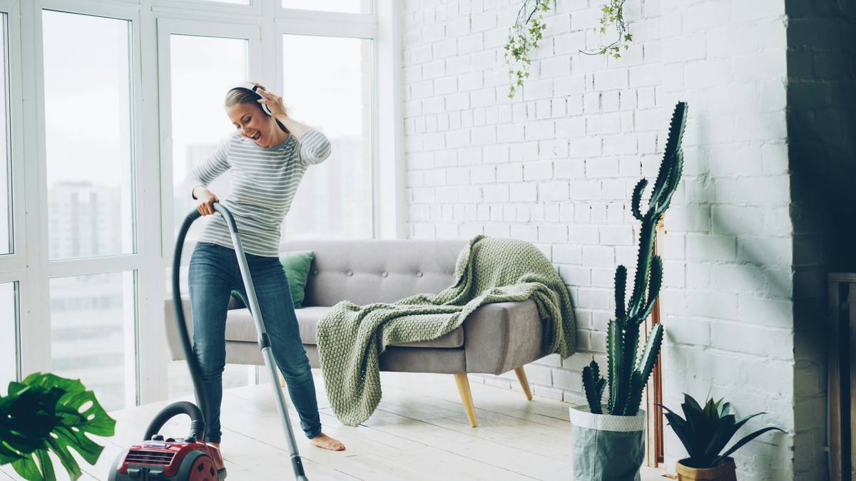 Woman using vinegar and baking soda for eco-friendly cleaning to achieve health benefits of a clean home