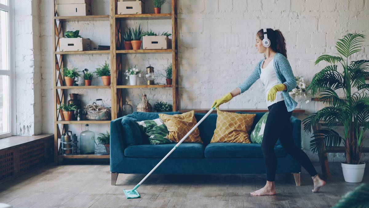 Professional eco friendly home cleaning services team using plant-based products on kitchen surfaces