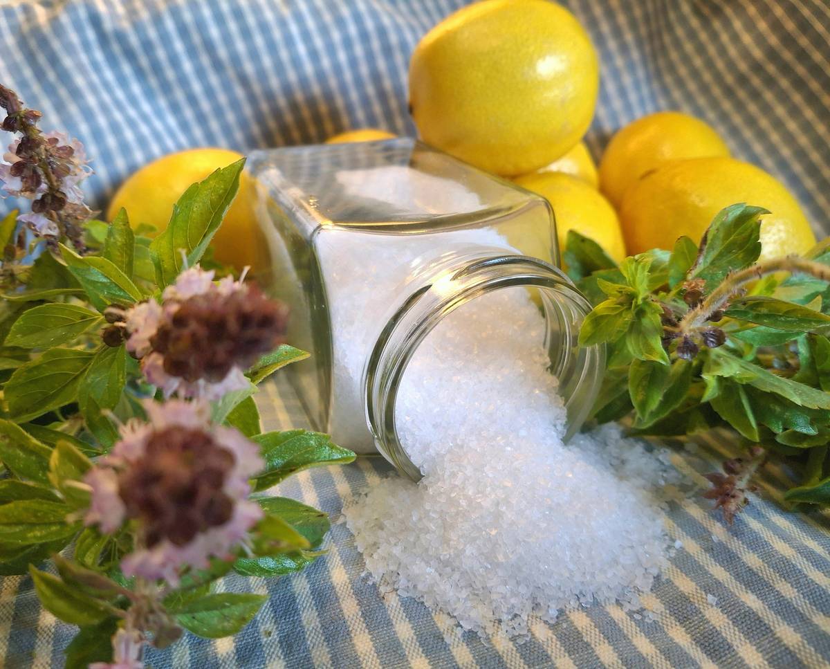 Printable diy natural household cleaners pdf with vinegar, baking soda, and spray bottles on a wooden counter